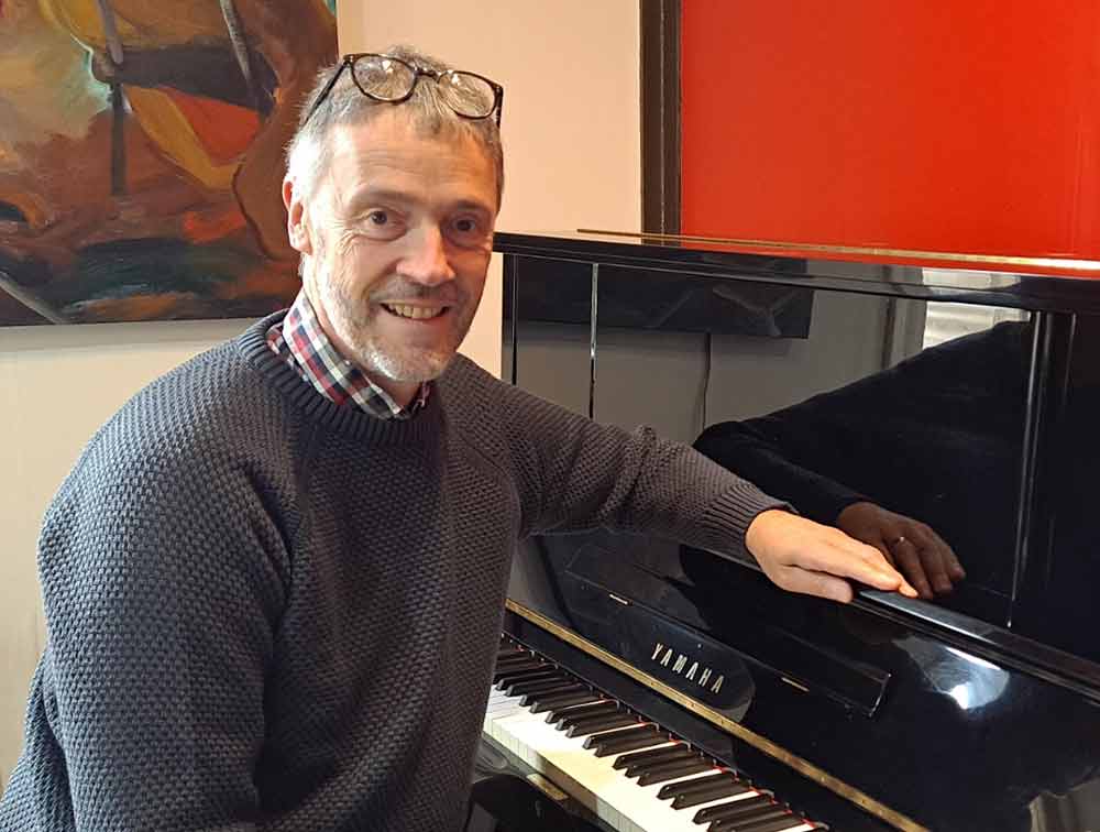 Mark Bolsis tunes Lucy,s piano